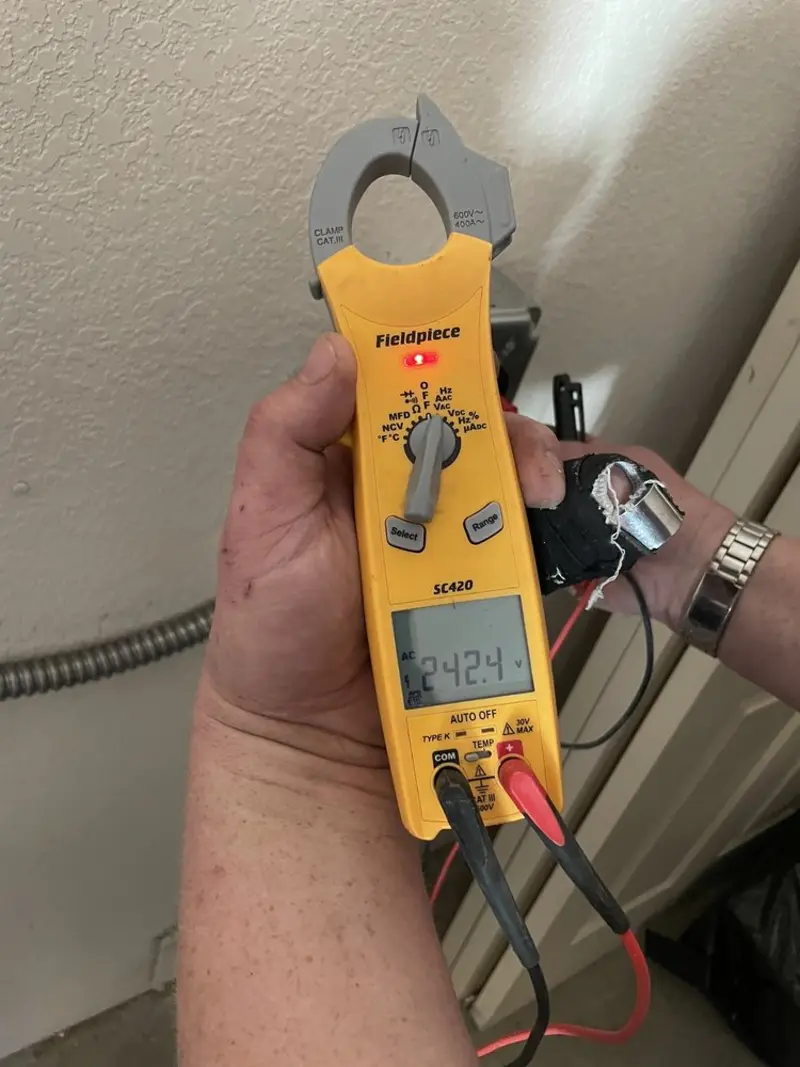 Voltage testing with clamp meter during Whole House Surge Protector in Willowick